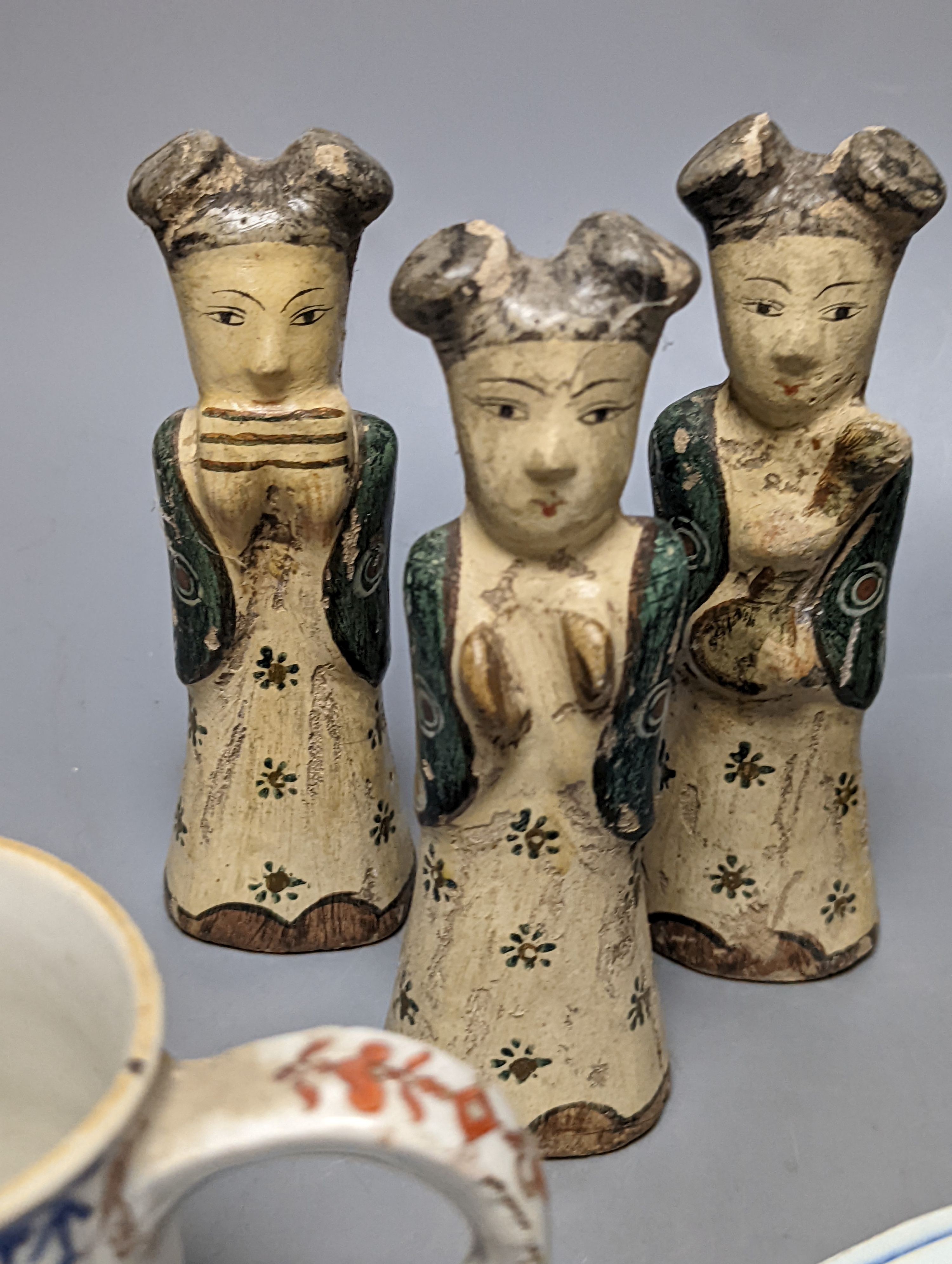 Six Chinese pottery figures and a mug and two plates, largest plate 24 cms diameter.
